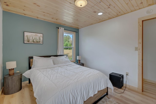 bedroom featuring wood ceiling and light hardwood / wood-style flooring