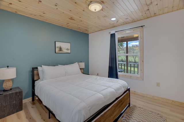 bedroom with light hardwood / wood-style flooring and wooden ceiling