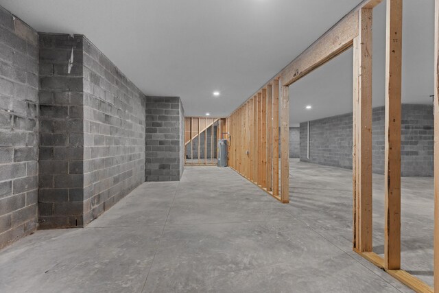 unfinished below grade area with concrete block wall and recessed lighting