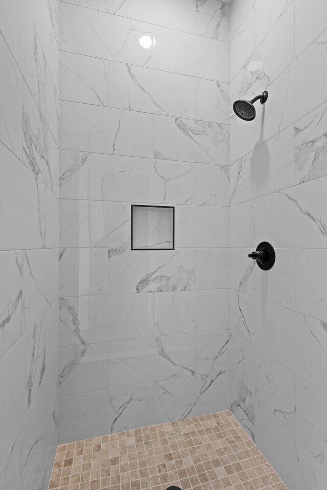 full bathroom with a tile shower