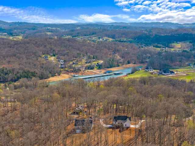 aerial view featuring a wooded view and a water view