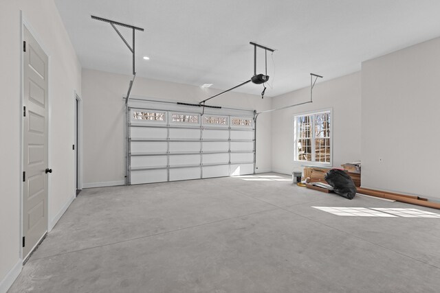 garage with baseboards and a garage door opener