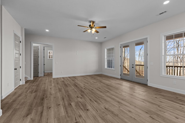 unfurnished living room featuring recessed lighting, french doors, baseboards, a ceiling fan, and wood finished floors