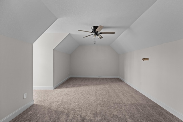 additional living space with baseboards, lofted ceiling, ceiling fan, and carpet
