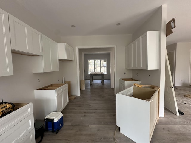 kitchen featuring hardwood / wood-style floors and white cabinets