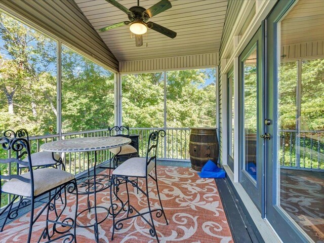 sunroom featuring ceiling fan and lofted ceiling