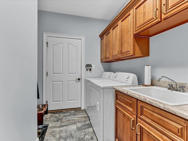 laundry area featuring separate washer and dryer, sink, and cabinets