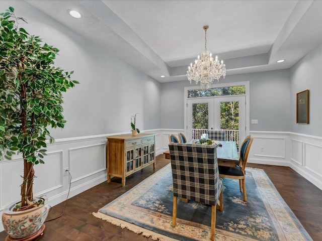 dining area with french doors, dark hardwood / wood-style flooring, and a tray ceiling