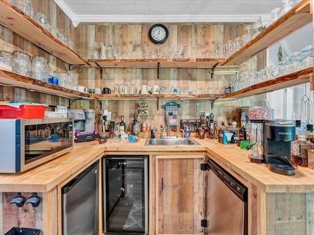 bar with wine cooler, stainless steel appliances, and wood counters