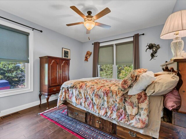 bedroom featuring ceiling fan and dark wood-type flooring