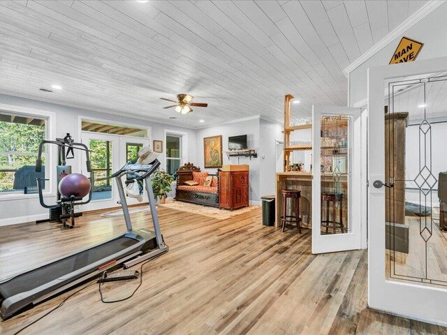 workout area with wooden ceiling, french doors, ceiling fan, light wood-type flooring, and ornamental molding