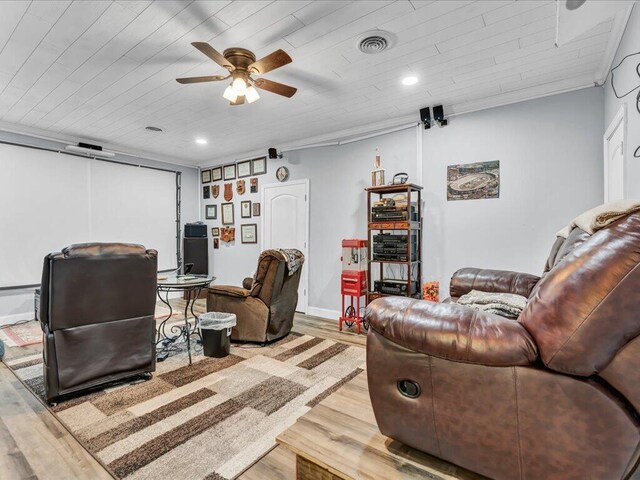 living room featuring ceiling fan, ornamental molding, wooden ceiling, and light wood-type flooring