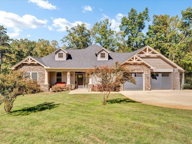 view of front of house with a front lawn, covered porch, and a garage