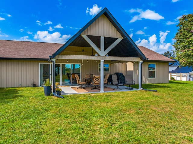 back of property with a lawn and a patio area