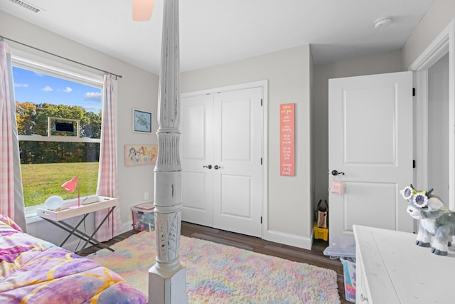 bedroom featuring ceiling fan, dark wood-type flooring, and a closet