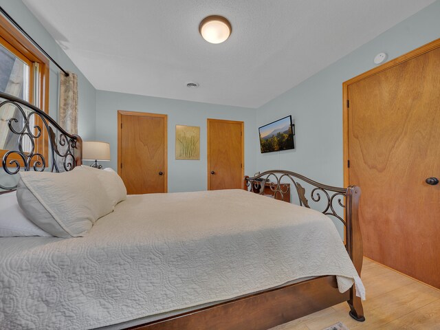 bedroom with light wood-type flooring