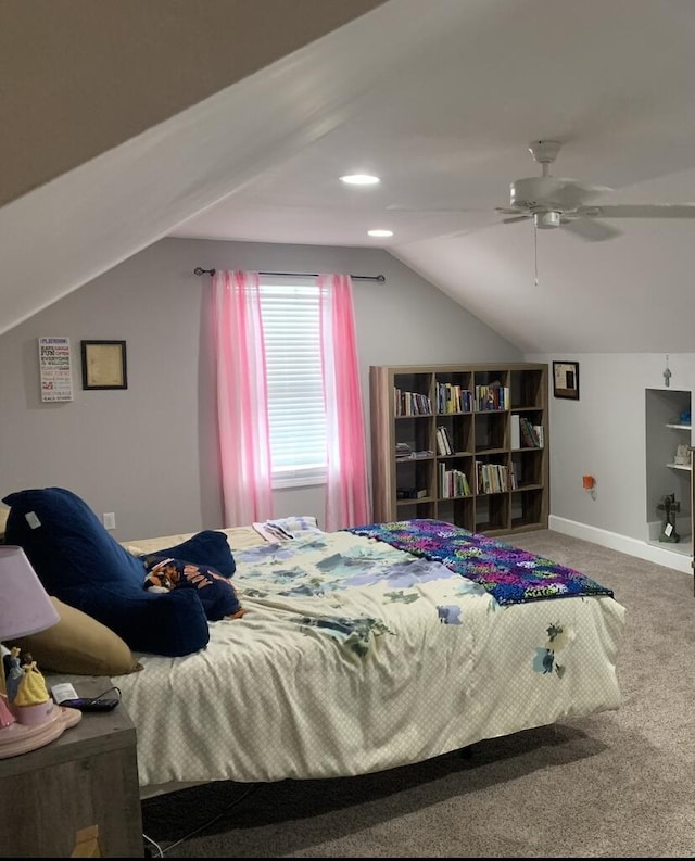 carpeted bedroom with baseboards and vaulted ceiling