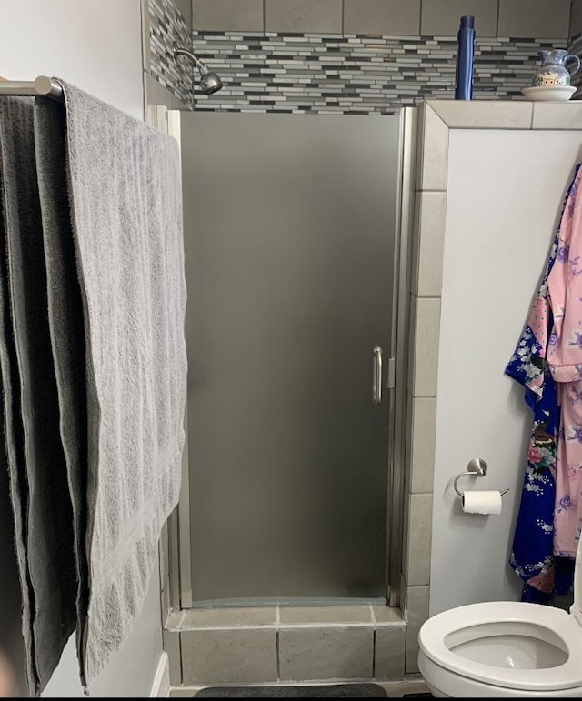full bath with a stall shower and toilet
