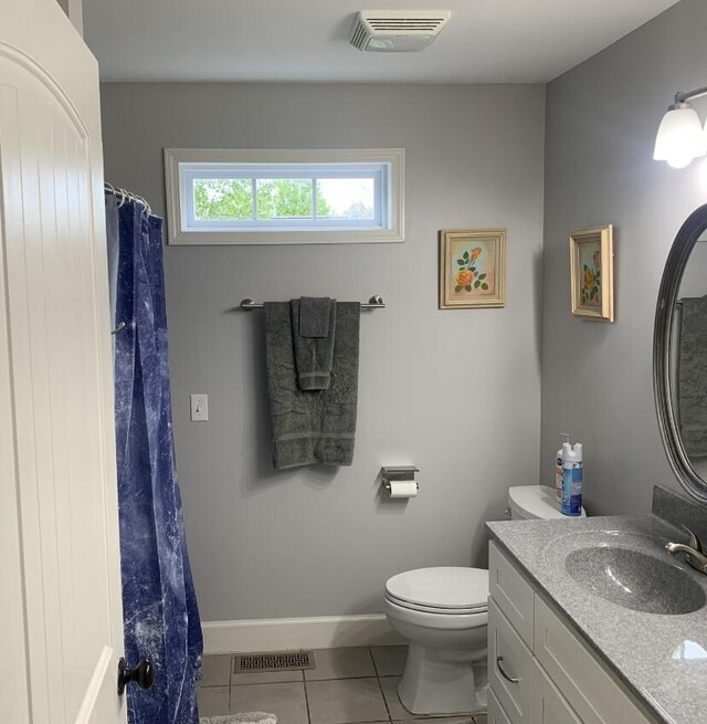 bathroom featuring visible vents, tile patterned floors, toilet, and vanity