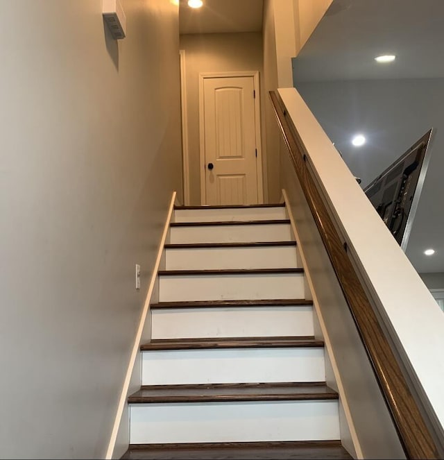 staircase featuring recessed lighting