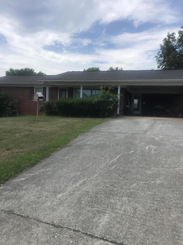 single story home featuring a front yard and a carport