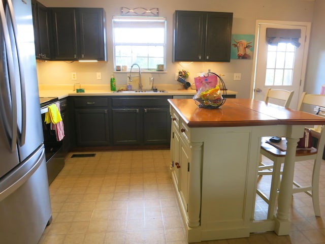 5534 Carlyle Ave, Russellville, TN 37860 - kitchen featuring a sink, freestanding refrigerator, electric range oven, and plenty of natural light