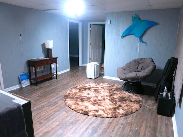 5534 Carlyle Ave, Russellville, TN 37860 - living area featuring wood finished floors, a drop ceiling, baseboards, and wooden walls