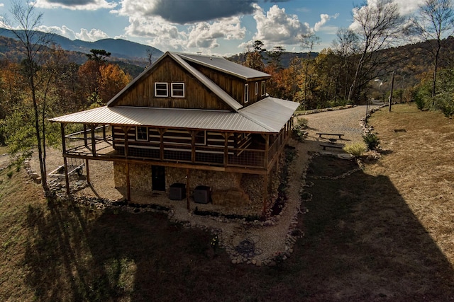 rear view of house featuring a deck with mountain view