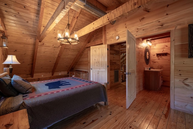 bedroom featuring an inviting chandelier, wooden walls, vaulted ceiling with beams, light hardwood / wood-style floors, and wood ceiling