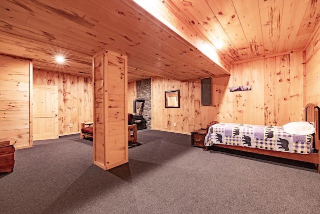 carpeted bedroom with electric panel, wooden ceiling, and wood walls