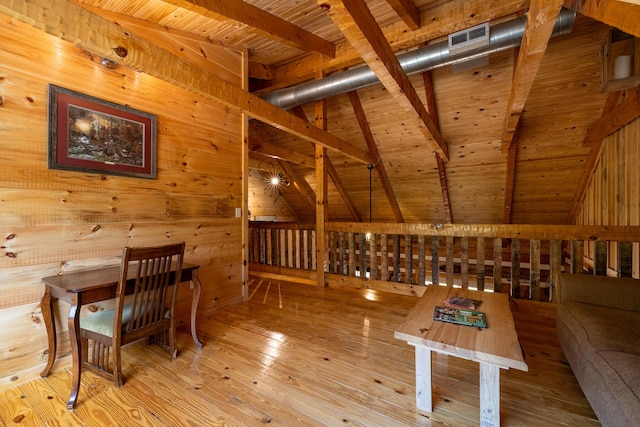 interior space with lofted ceiling with beams, wood walls, wood ceiling, and light hardwood / wood-style floors