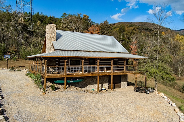 rear view of house featuring a deck