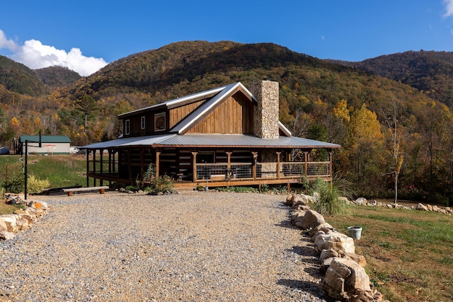 view of front of property featuring a deck with mountain view