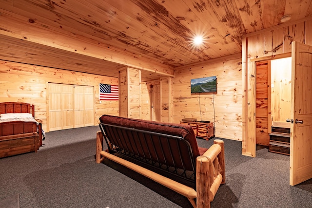 bedroom featuring dark carpet, wooden ceiling, and wooden walls