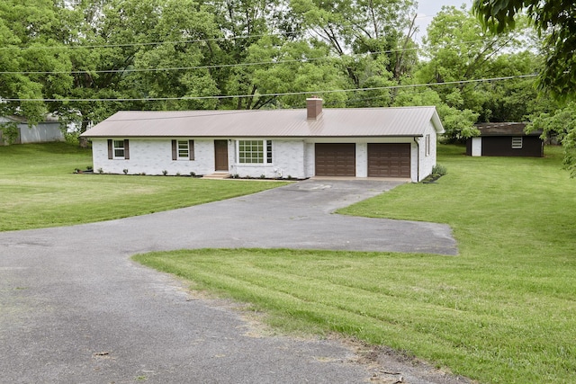 ranch-style house featuring a front lawn, a shed, and a garage