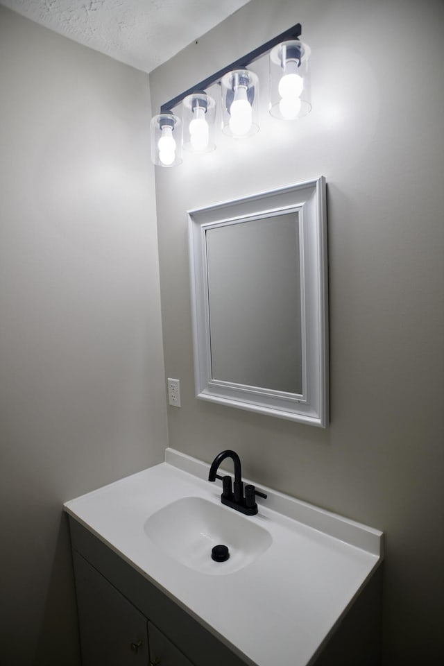 bathroom featuring vanity and a textured ceiling