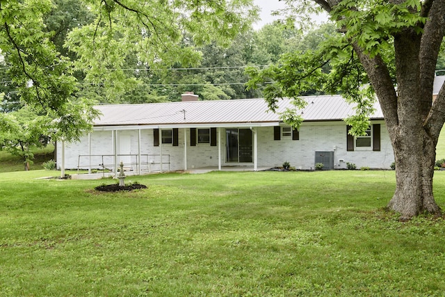 back of property featuring a yard