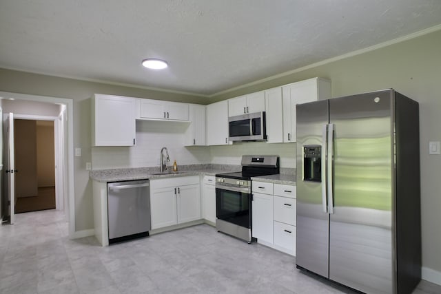 kitchen featuring sink, crown molding, decorative backsplash, white cabinets, and appliances with stainless steel finishes