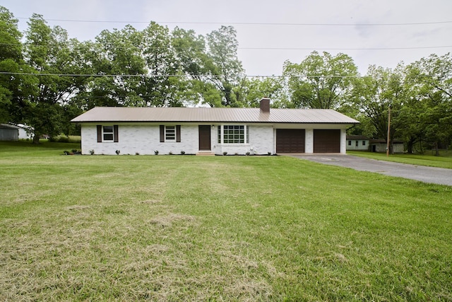 ranch-style home featuring a garage and a front lawn