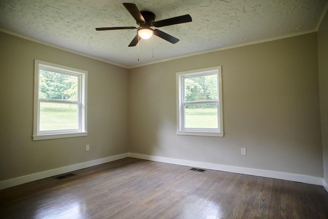 spare room featuring a wealth of natural light, crown molding, ceiling fan, and hardwood / wood-style floors