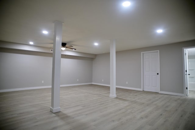 basement with ceiling fan and light hardwood / wood-style flooring