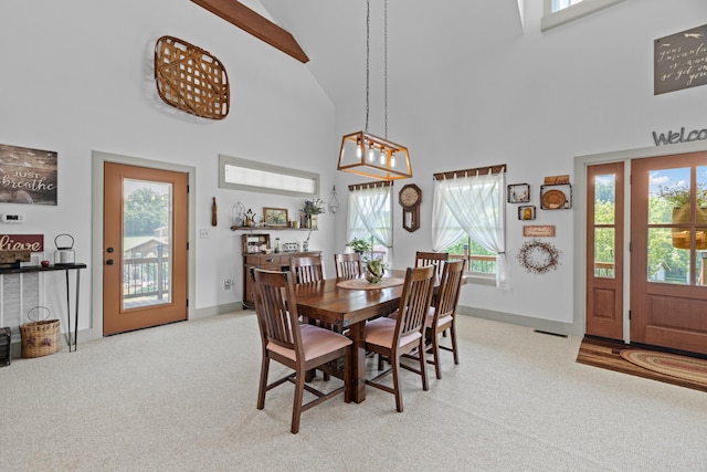 2545 Amanda Ln, Sevierville, TN 37876 - dining room featuring light carpet, healthy amount of natural light, high vaulted ceiling, and baseboards
