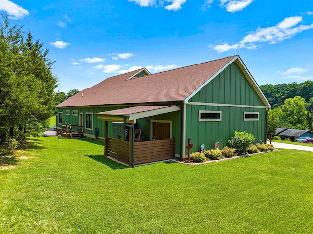 2545 Amanda Ln, Sevierville, TN 37876 - back of house with board and batten siding, roof with shingles, a yard, and a deck