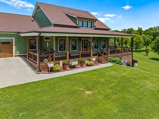 2545 Amanda Ln, Sevierville, TN 37876 - country-style home with covered porch, board and batten siding, a front yard, driveway, and a garage