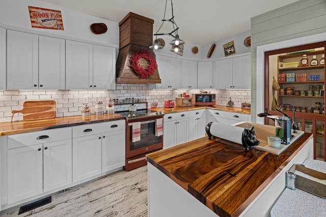 2545 Amanda Ln, Sevierville, TN 37876 - kitchen featuring wood counters, stainless steel range with electric stovetop, tasteful backsplash, and white cabinets