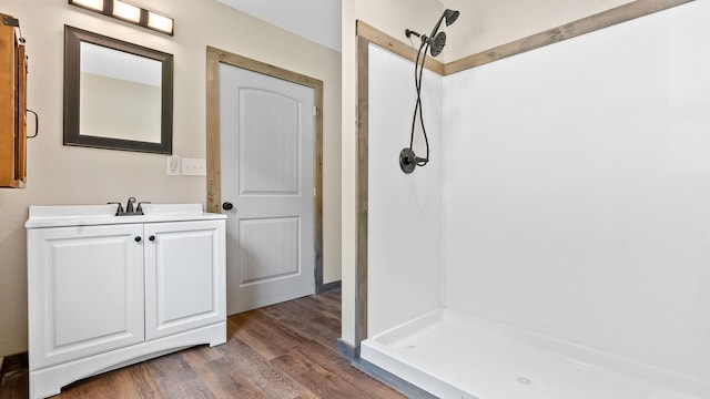 bathroom with vanity, hardwood / wood-style floors, and walk in shower