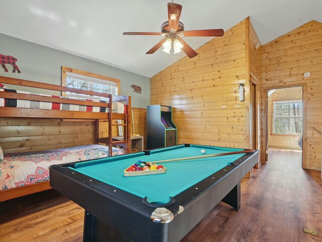 game room featuring wood finished floors, lofted ceiling, wood walls, and billiards