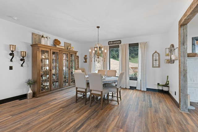 dining room with a notable chandelier and dark hardwood / wood-style flooring