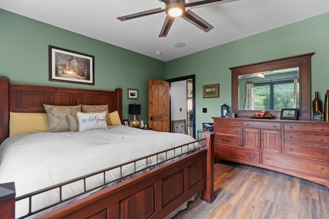 bedroom with ceiling fan and hardwood / wood-style flooring