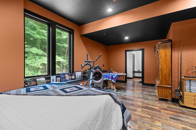 bedroom with dark hardwood / wood-style floors